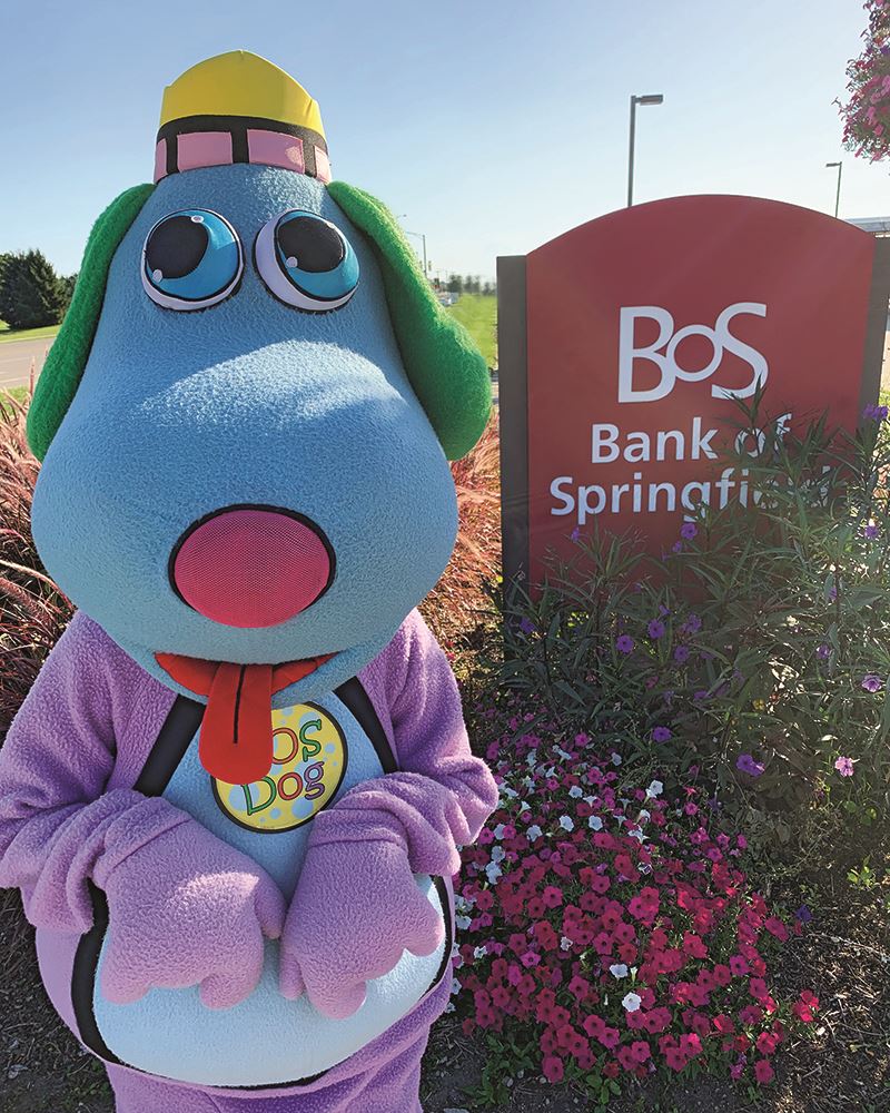 The Bank of Springfield mascot posing next to a bank sign.